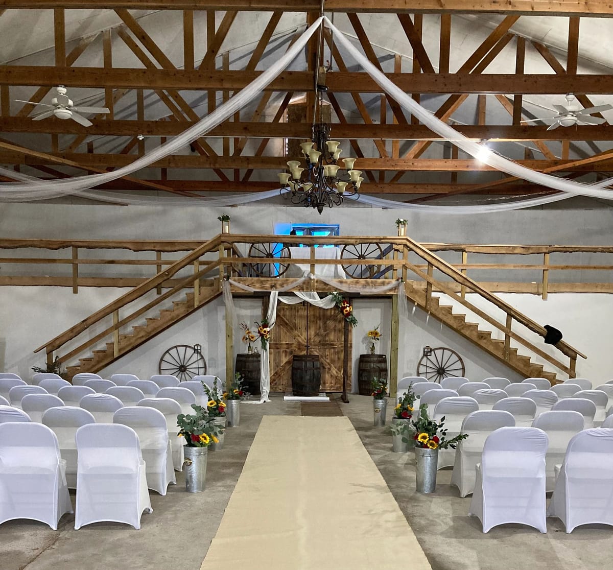 Inside the restored DnB Barn, draped with warm string lights and set with tables for a reception