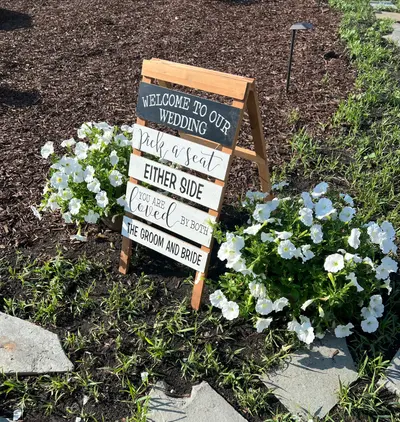 A chalkboard welcome sign with blue hydrangeas