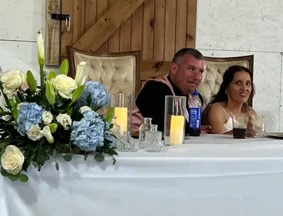 Guests gathered at a floral-topped table during the reception
